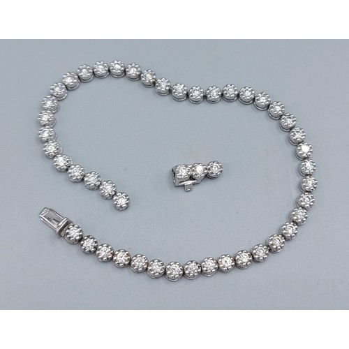 An 18ct white gold Diamond set line bracelet, 12.8gms, 19.5cms long