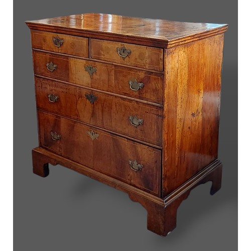 218 - A George III walnut chest, the line inlaid top above two short and three long drawers with brass han... 