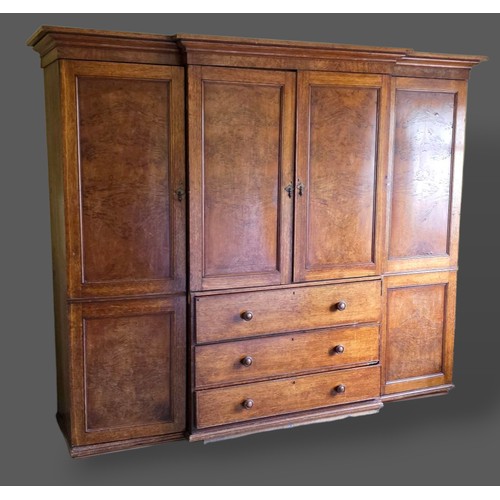 223 - A Victorian Pollard oak breakfront wardrobe, the moulded cornice above two central doors enclosing s... 