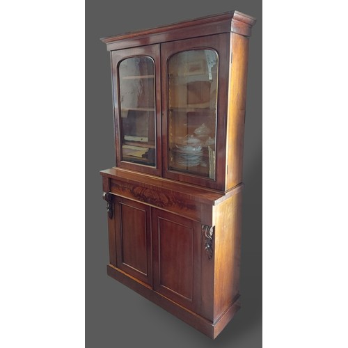 225 - A Victorian mahogany bookcase, the moulded cornice above two glazed doors enclosing shelves, the low... 