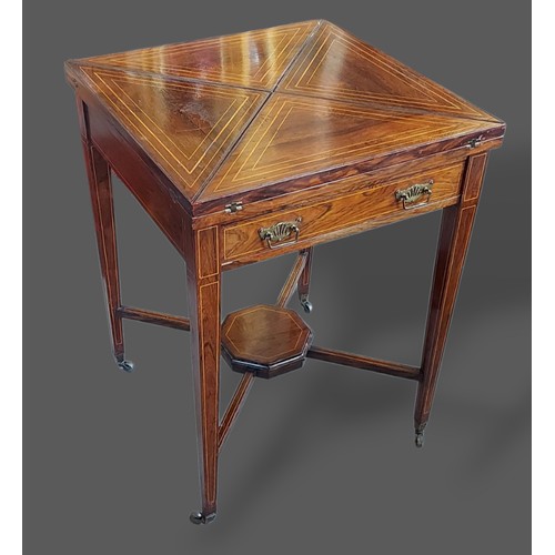 226 - An Edwardian Rosewood line inlaid envelope card table with a frieze drawer raised upon square taperi... 