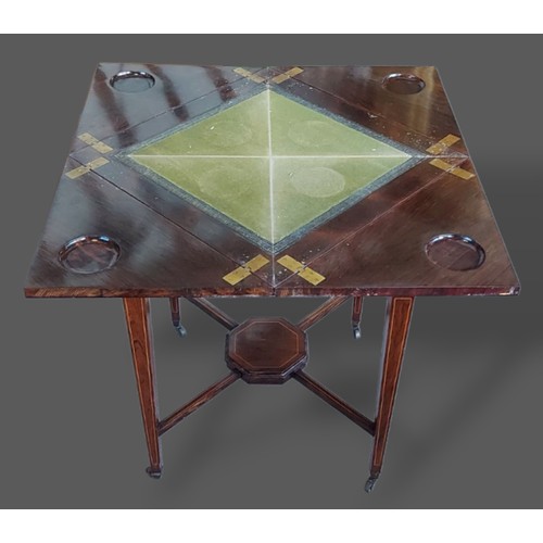 226 - An Edwardian Rosewood line inlaid envelope card table with a frieze drawer raised upon square taperi... 