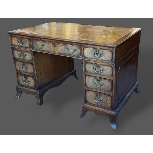 229 - A mahogany twin pedestal desk, the tooled leather inset top above nine drawers with brass handles ra... 