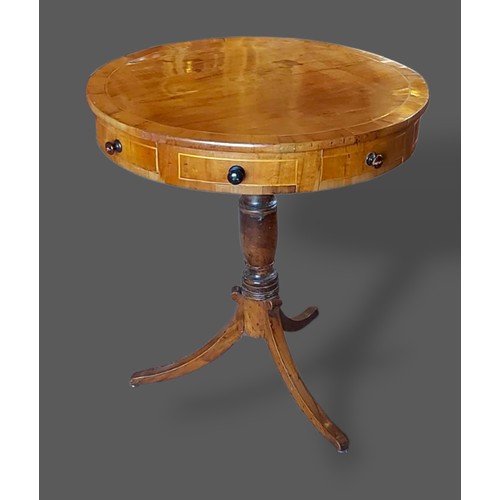 233 - A 19th century mahogany and yew banded circular drum table, the moulded top above four drawers and f... 