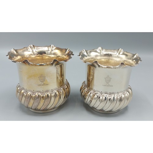 81 - A pair of Edwardian silver vases of half lobed form, each bearing an engraved crest, Chester 1901, m... 