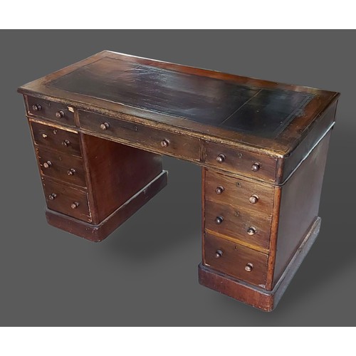 250 - A Victorian twin pedestal desk, the tooled leather inset top above nine drwers with knob handles, 12... 