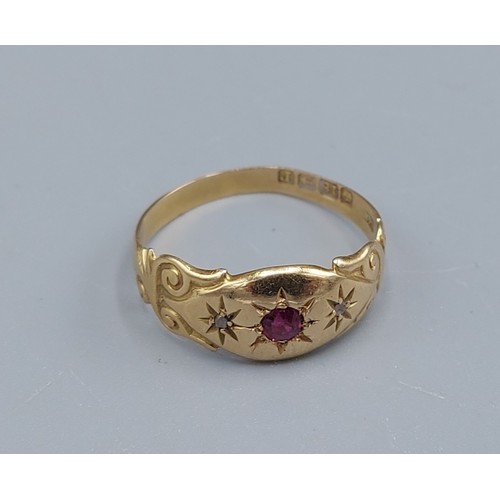 99 - An 18ct gold Ruby and Diamond ring set with a central Ruby flanked by Diamonds, 2.1gms, ring size O