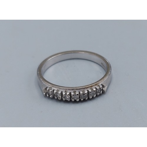 100 - An 18ct white gold seven stone Diamond ring 2.3gms, ring size J