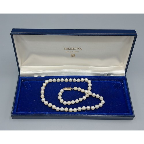 105 - A single row cultured Pearl necklace by Mikimoto with 9ct gold clasp, 40cms long
