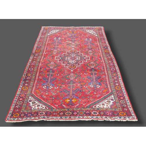206 - A North West Persian woollen rug with all over design upon a red and cream ground, 150cms by 290cms