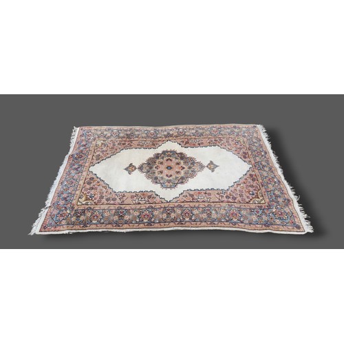 207 - A Northwest Persian woollen rug with a central medallion within an all-over design upon a pale groun... 