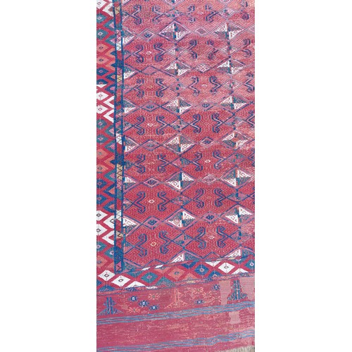 208 - A Tekke woollen rug with rows of Guls upon a red ground within multiple borders, 208cms x 328cms