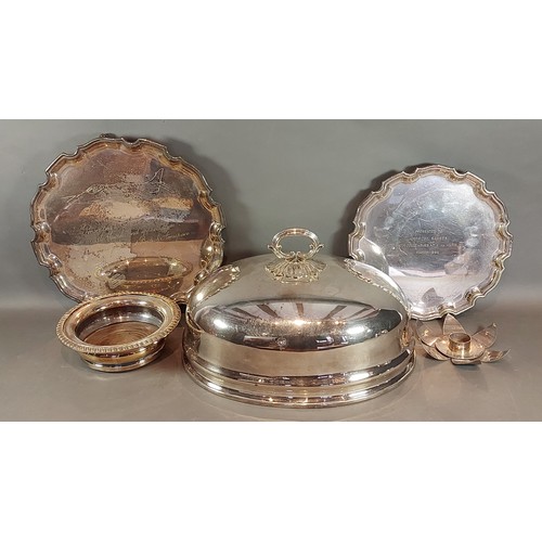 110 - A silver plated meat dish cover together with two plated trays, a plated candle stand and a bottle c... 
