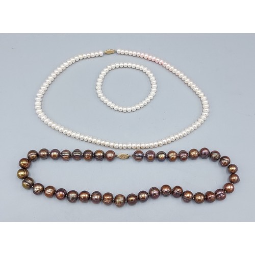 113 - A cultured Pearl necklace with 14ct gold clasp together with another similar cultured Pearl necklace... 