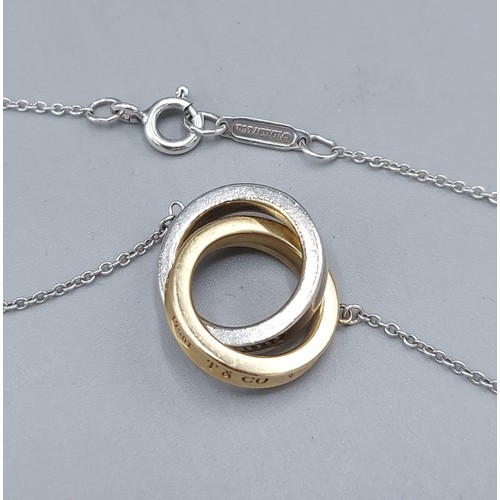 119 - A Tiffany & Co 18ct gold and silver interlocking circle pendant with 925 silver chain, 6gms
