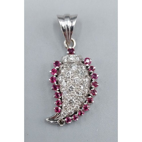 120 - A white gold pendant in the form of a leaf set with Rubies and Diamonds, 3cms long, 3.7gms