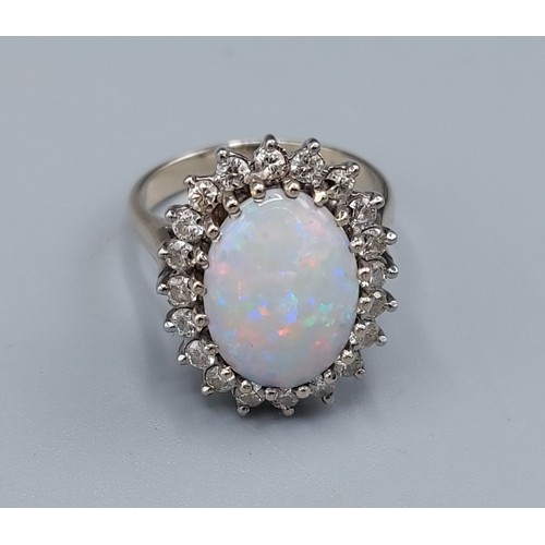 124 - An 18ct white gold Opal and Diamond cluster ring set with large central oval Opal surrounded by Diam... 