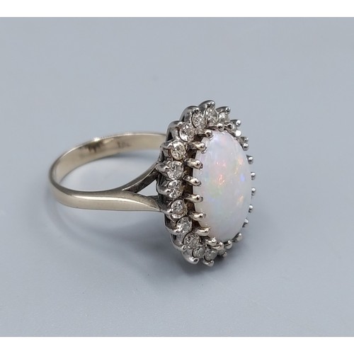 124 - An 18ct white gold Opal and Diamond cluster ring set with large central oval Opal surrounded by Diam... 