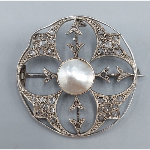 126 - A white gold brooch of circular pierced form set with central Pearl surrounded with Diamond clusters... 