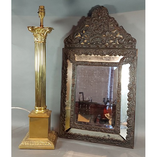 201 - A brass lamp of column form together with a metal mounted wall mirror