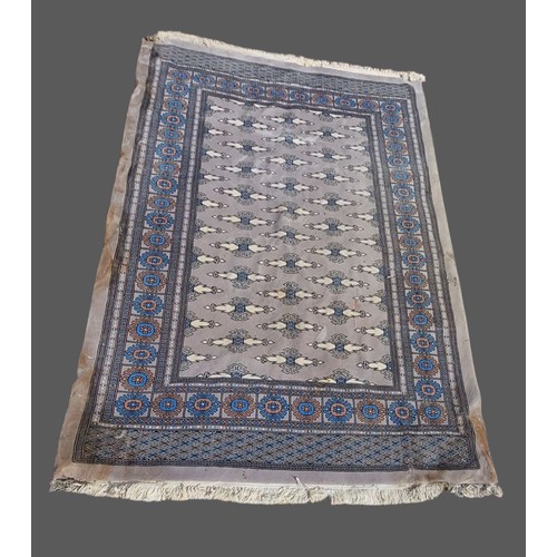 209 - A woollen carpet with an all-over design upon a pale blue ground within multiple borders, 298cms x 3... 
