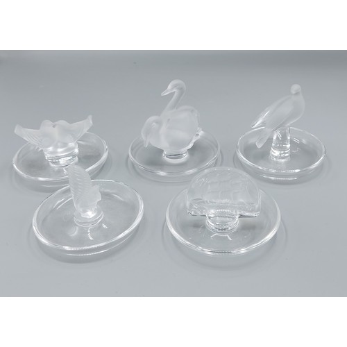 A Lalique glass pin tray mounted with two Swans together with four ...