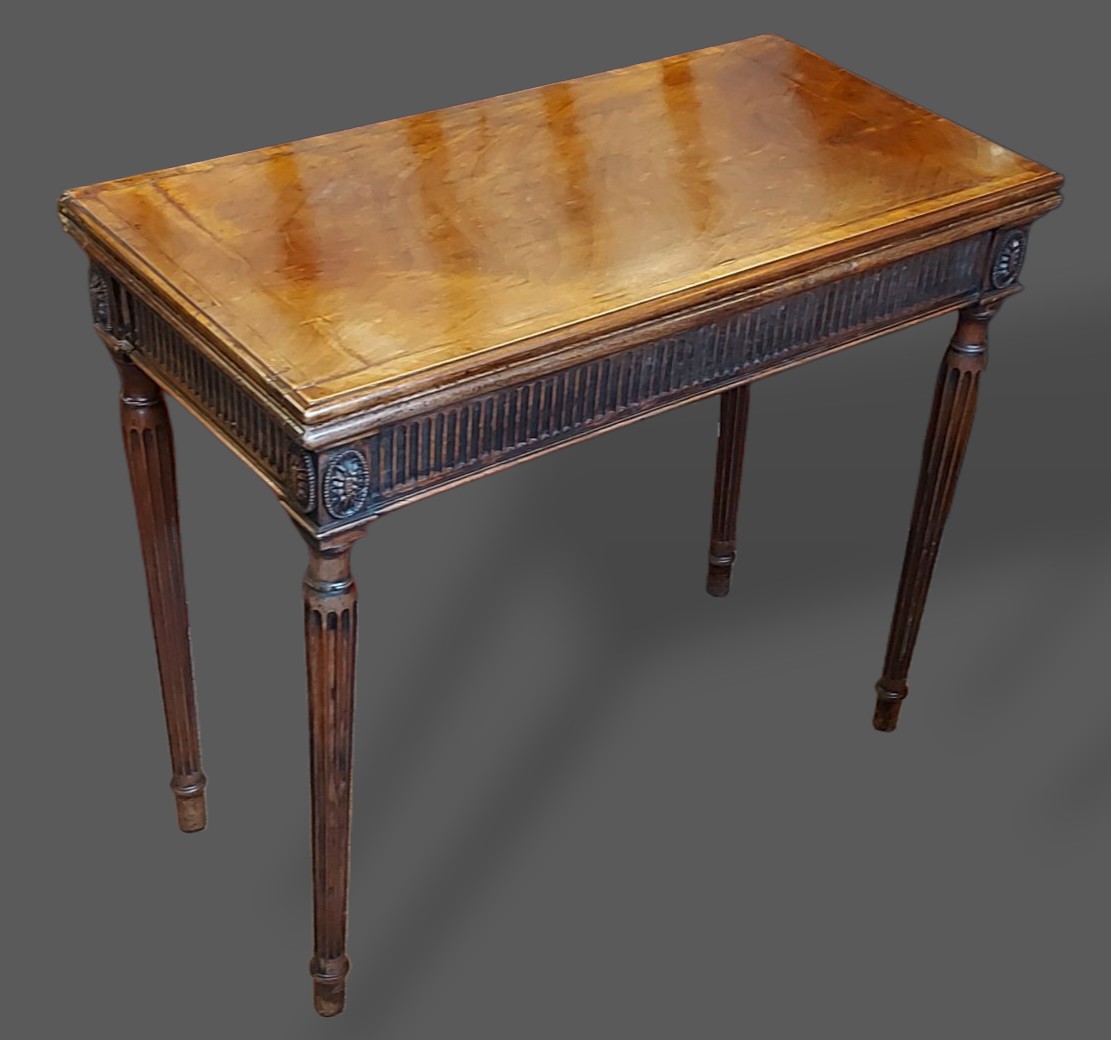 A mahogany rectangular card table, the hinged top enclosing a beize ...