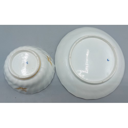 34 - A set of six Worcester tea bowls and saucers with gilt decoration upon a white and blue ground