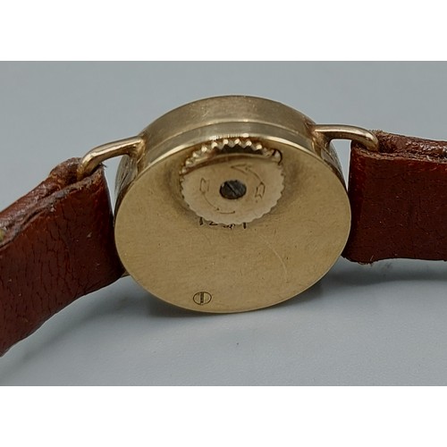 80 - A 9ct gold cased ladies wristwatch by Jaegar LeCoultre with leather strap