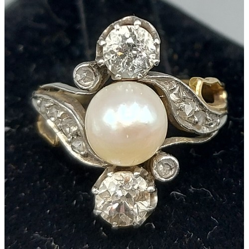 84 - A gold ring set with a central Pearl flanked by two Diamonds within a Diamond mounted scroll setting... 