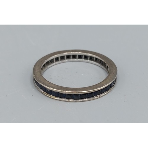 89 - A white gold Sapphire set full Eternity ring, 2.7gms, ring size  K