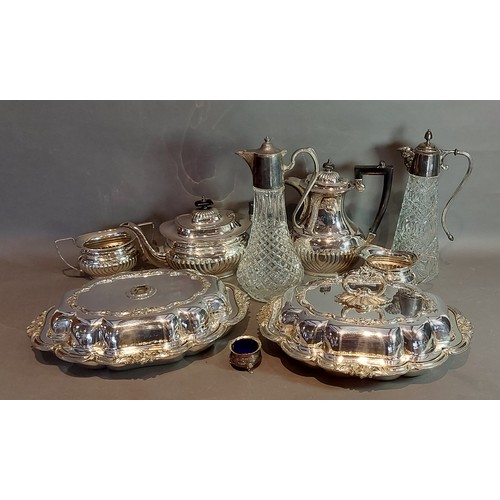 111 - A silver plated tea service together with a pair of silver plated entree dishes and two claret jugs
