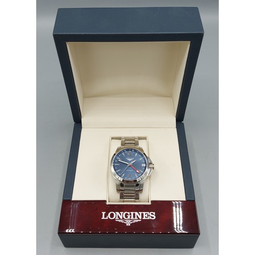112 - A Longines Conquest stainless steel cased gentlemans wristwatch with blue dial and within original b... 