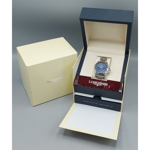 112 - A Longines Conquest stainless steel cased gentlemans wristwatch with blue dial and within original b... 