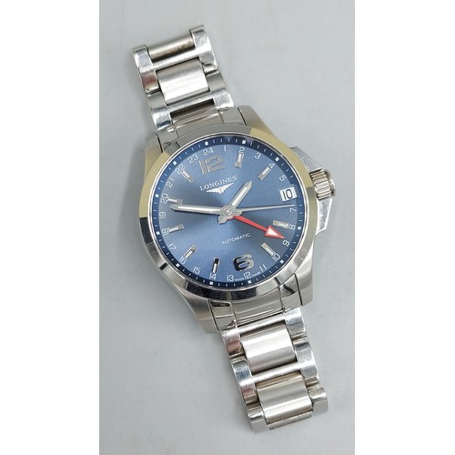 112 - A Longines Conquest stainless steel cased gentlemans wristwatch with blue dial and within original b... 