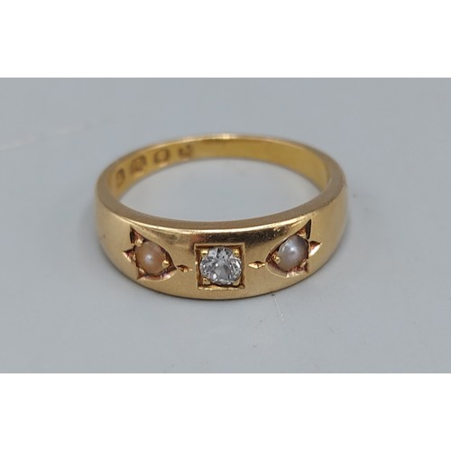 120 - An 18ct gold ring set with a central Diamond flanked by Pearls, 4.8gms, ring size M