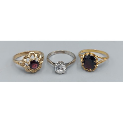 126 - A 9ct gold Garnet set dress ring together with two other 9ct gold dress rings, combined weight 7.3gm... 