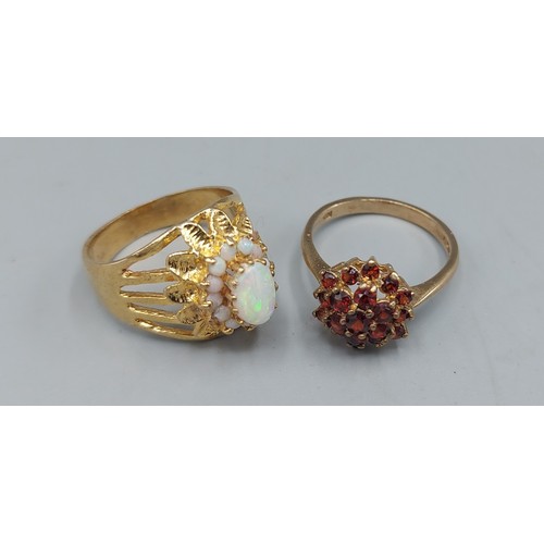127 - A 9ct gold Opal set dress ring, ring size O together with a 9ct gold Garnet set dress ring, ring siz... 