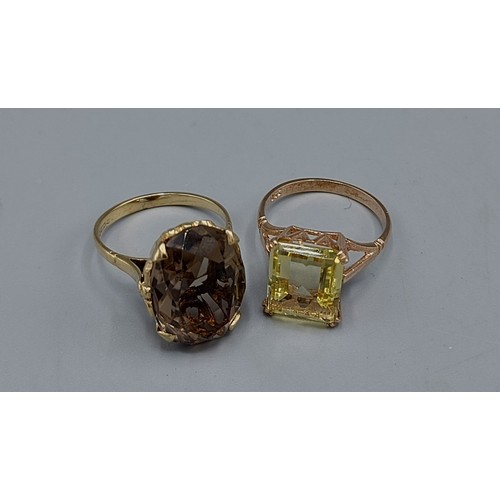 128 - A 9ct gold stone set dress ring together with another similar 9ct gold dress ring, combined weight 9... 