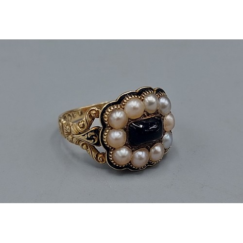 132 - A 19th Century 18ct gold mourning ring set with a cabochon Garnet surrounded by Pearls within a shap... 