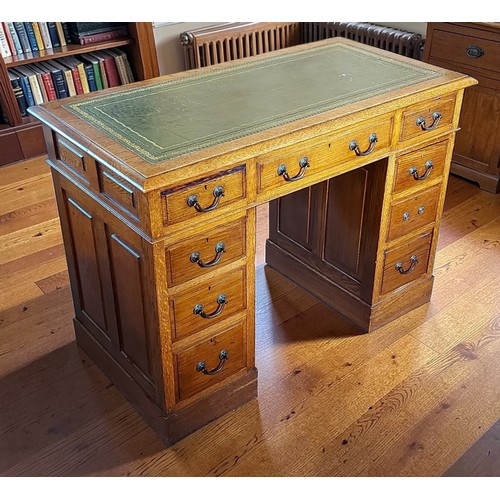 353 - An Edwardian oak twin pedestal desk, the tooled leather inset top above eight drawers with brass han... 