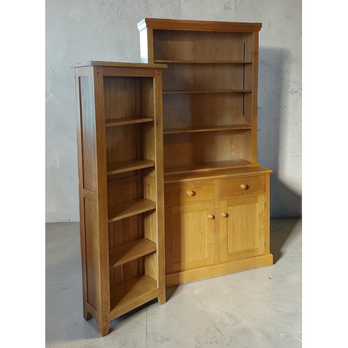 355 - A 20th Century oak bookcase, the moulded cornice above open shelves, the lower section with two draw... 