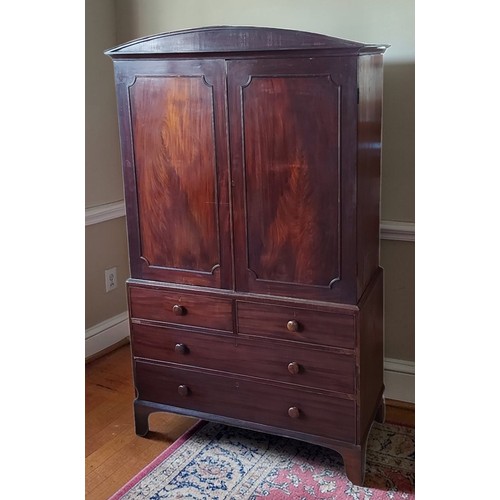 358 - A Regency mahogany Press Cupboard, the shaped moulded cornice above two panel doors enclosing a hang... 