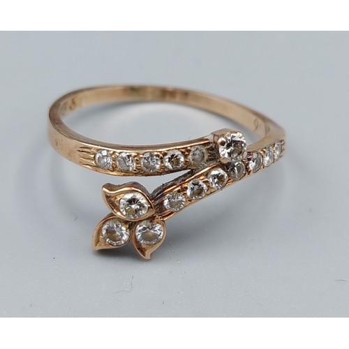 130 - A 14ct gold Diamond set ring of shaped crossover form, 1.7gms, ring size M