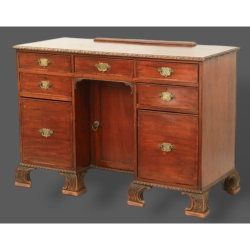 366 - A 19th Century mahogany kneehole desk, the carved moulded top above seven drawers and central cupboa... 