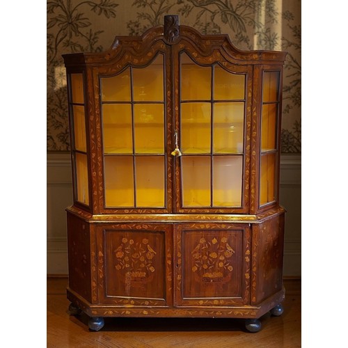 348 - A 19th Century Dutch Marquetry inlaid cabinet, the shaped moulded cornice with central carving above... 