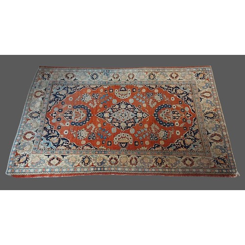 322 - A Northwest Persian woollen rug with a central medallion within an all-over design upon a terracotta... 