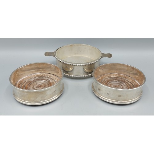 170 - A Chester silver dish with glass liner together with a pair of London silver bottle coasters