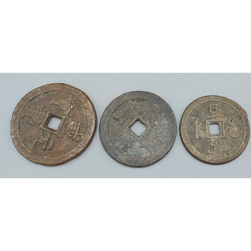 188 - Three early bronze Chinese coins decorated with Chinese script, 6cms, 5.5cms and 5cms diameter