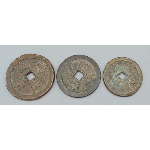 188 - Three early bronze Chinese coins decorated with Chinese script, 6cms, 5.5cms and 5cms diameter